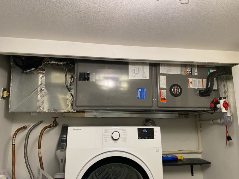 furnace installed on ceiling above white washer